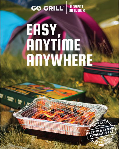 Go Grill disposable BBQ with flames lit on grassy campsite beside tents and packaging box, highlighting tagline ‘Easy, Anytime, Anywhere’ — NABL certified and food safe.